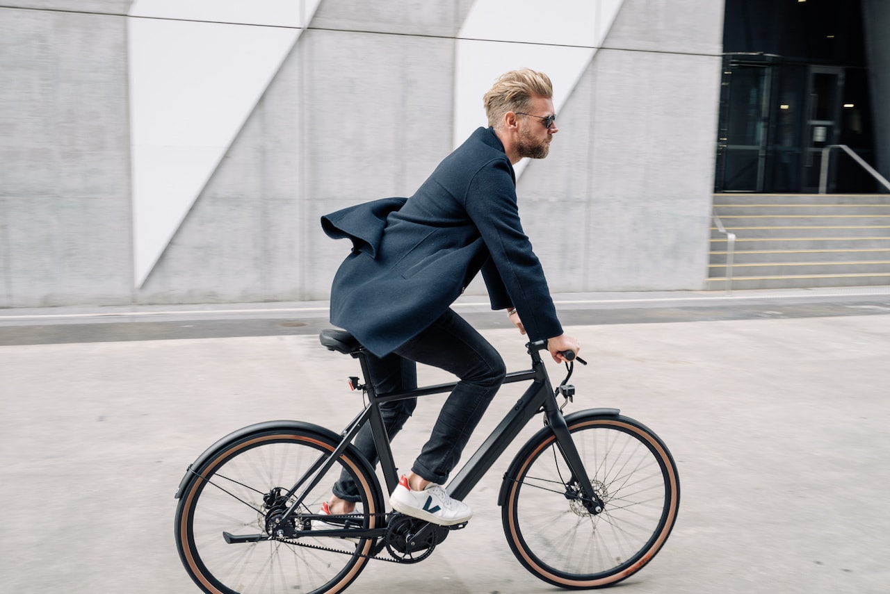 cool man cycles through amsterdam city centre