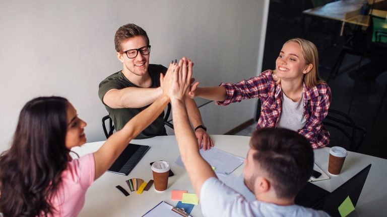 4 People giving high five to each other