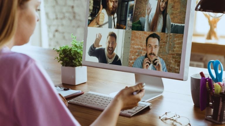 A person on a zoom call with 4 other people on the screen